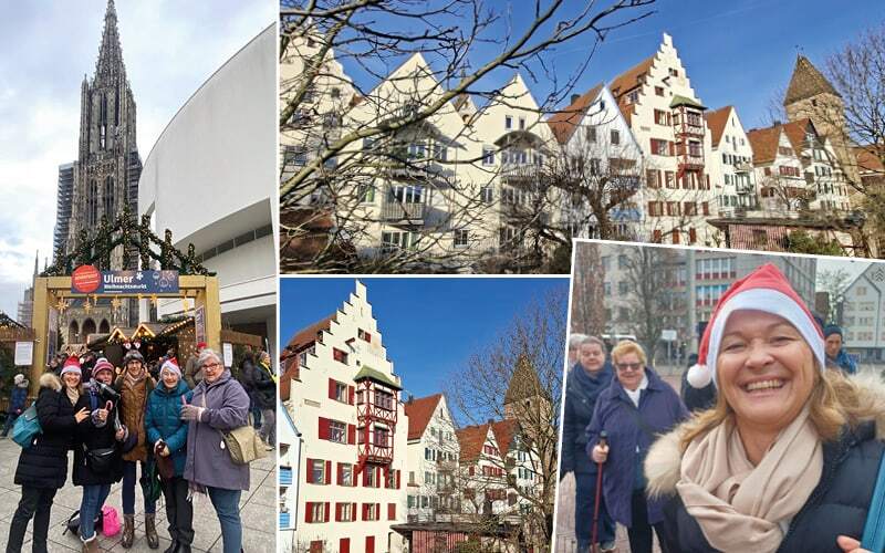 Voyageurs en bonnets de Noël devant le marché d’Ulm, cathédrale gothique et maisons à pignons