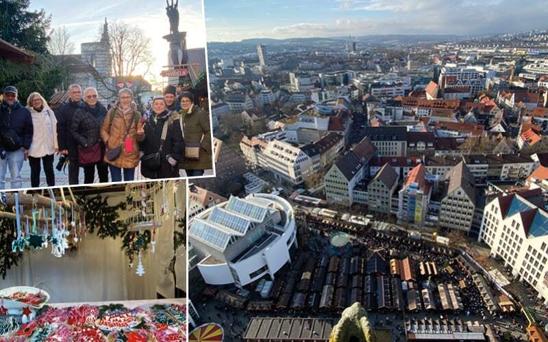 Vue plongeante sur les chalets du marché de Noël d’Ulm, décorations suspendues et groupe de voyageurs