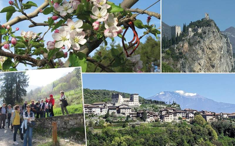 Fleurs de pommier, château perché sur un rocher, groupe en balade et village médiéval
