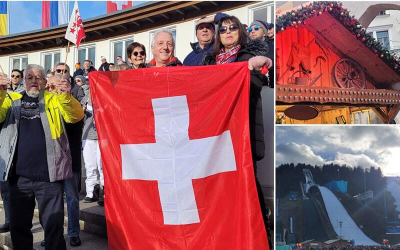 Voyageurs brandissant un drapeau suisse en tribune, chalet en bois décoré et tremplin de saut