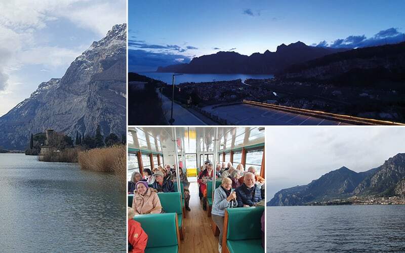 Château au bord d’un lac, lac de Garde au crépuscule et voyageurs en bateau