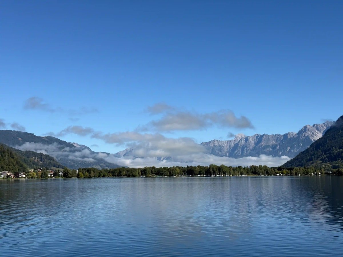Vue panoramique sur un lac du Salzkammergut entouré de montagnes sous un ciel bleu