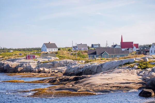 Küstenlandschaft von Peggys Cove mit Granitfelsen, kleinen Häusern und ruhigem Meer bei Tageslicht