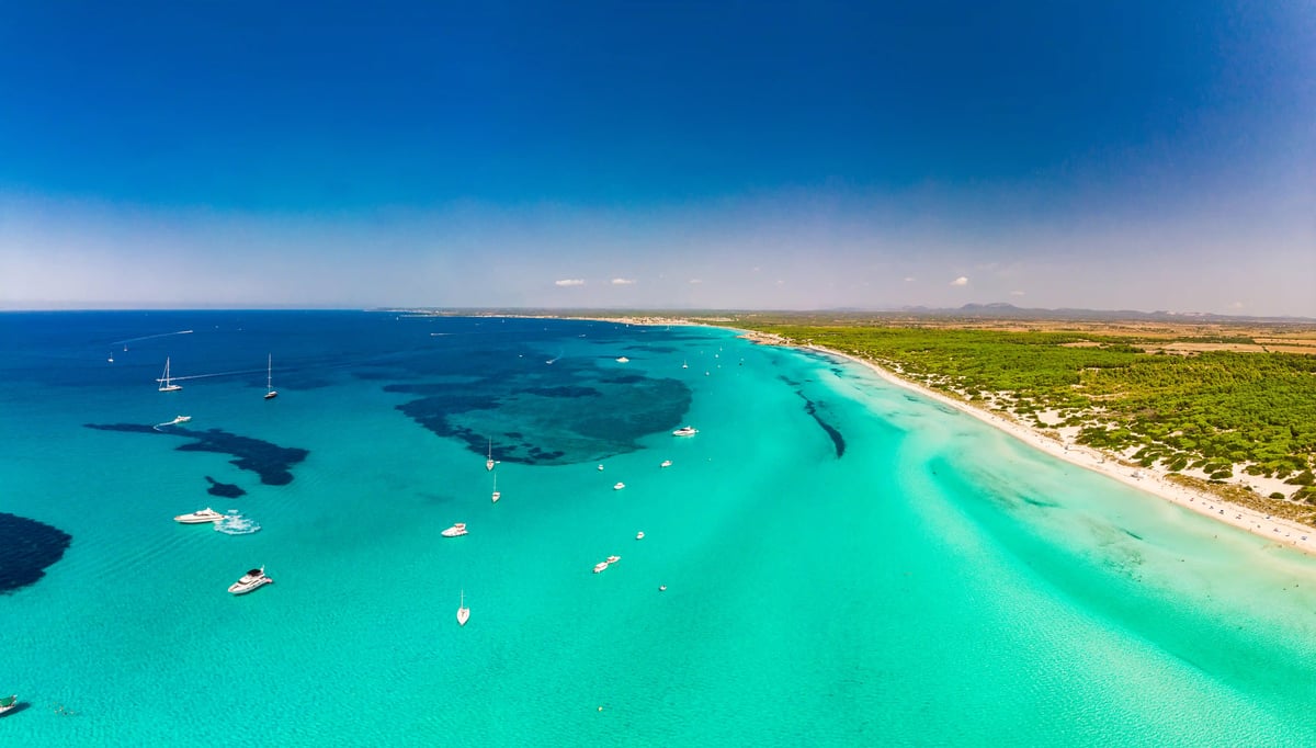 Luftaufnahme des Naturstrandes Es Trenc mit türkisfarbenem Wasser weissem Sand und Dünenlandschaft auf Mallorca