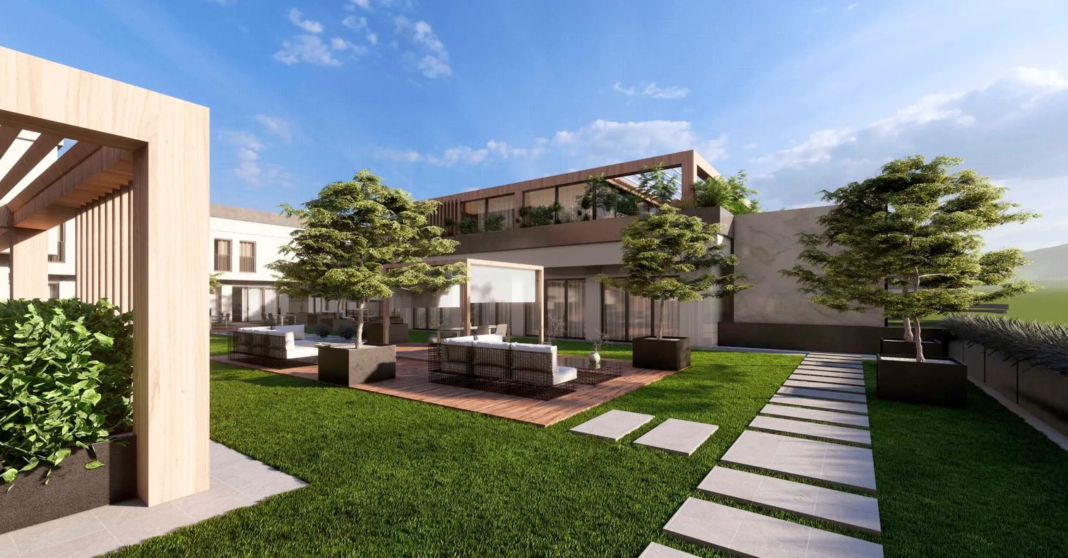 Moderne Hotelanlage mit begrüntem Innenhof, stilvollen Sitzbereichen, Bäumen in Pflanzkübeln und klar strukturierten Wegen unter blauem Himmel.