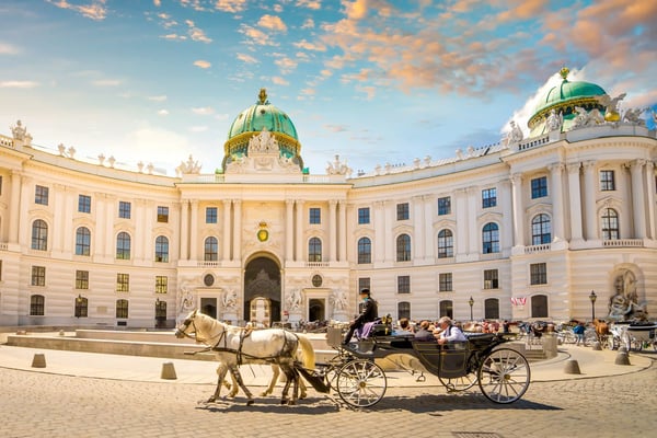 Kaiserliche Hofburg in Wien mit Kuppel, Torbogen und Pferdekutsche im Vordergrund