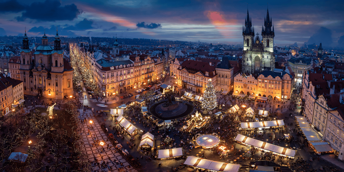 Blick über den weihnachtlich beleuchteten Altstädter Ring mit Weihnachtsmarkt und Teynkirche.