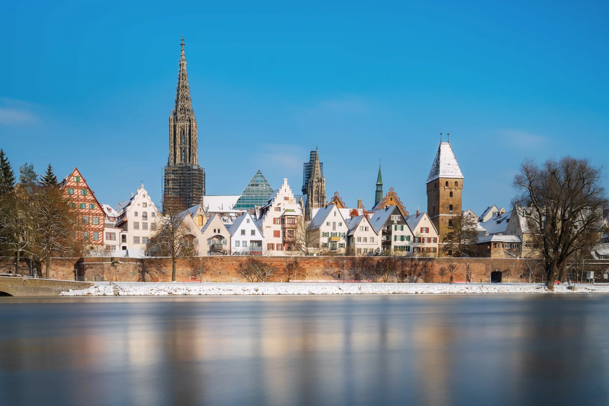 Ulmer Altstadt im Winter mit Münster und schneebedeckten Dächern an der Donau