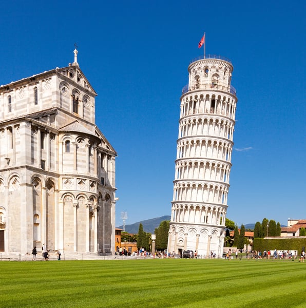 Schiefer Turm von Pisa neben Kathedrale unter blauem Himmel