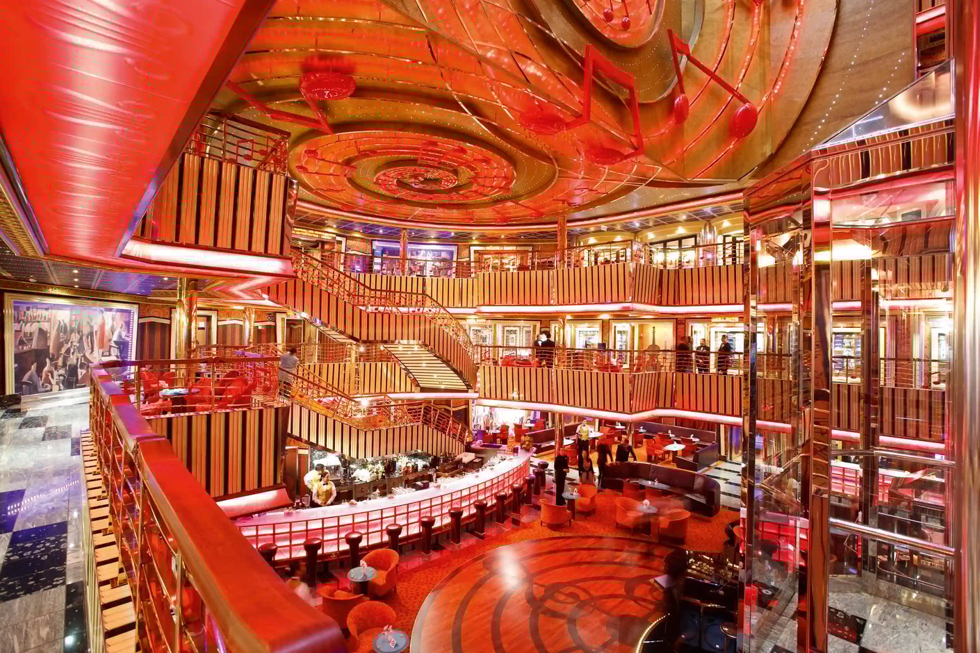 Grosses Atrium mit Bar, mehreren Decks, Treppen und roter Beleuchtung