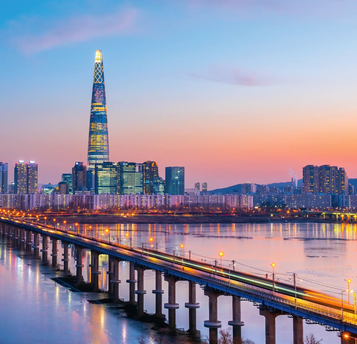 Skyline von Seoul mit dem Lotte World Tower bei Sonnenuntergang am Han-Fluss.