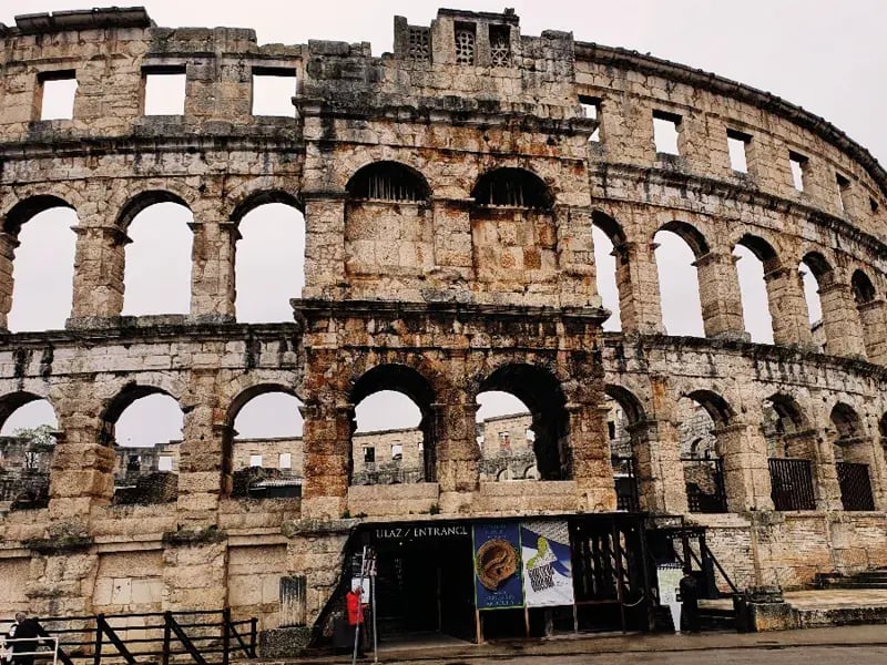 Antikes römisches Amphitheater aus Stein mit mehreren Bogenreihen und Eingangsbereich unten