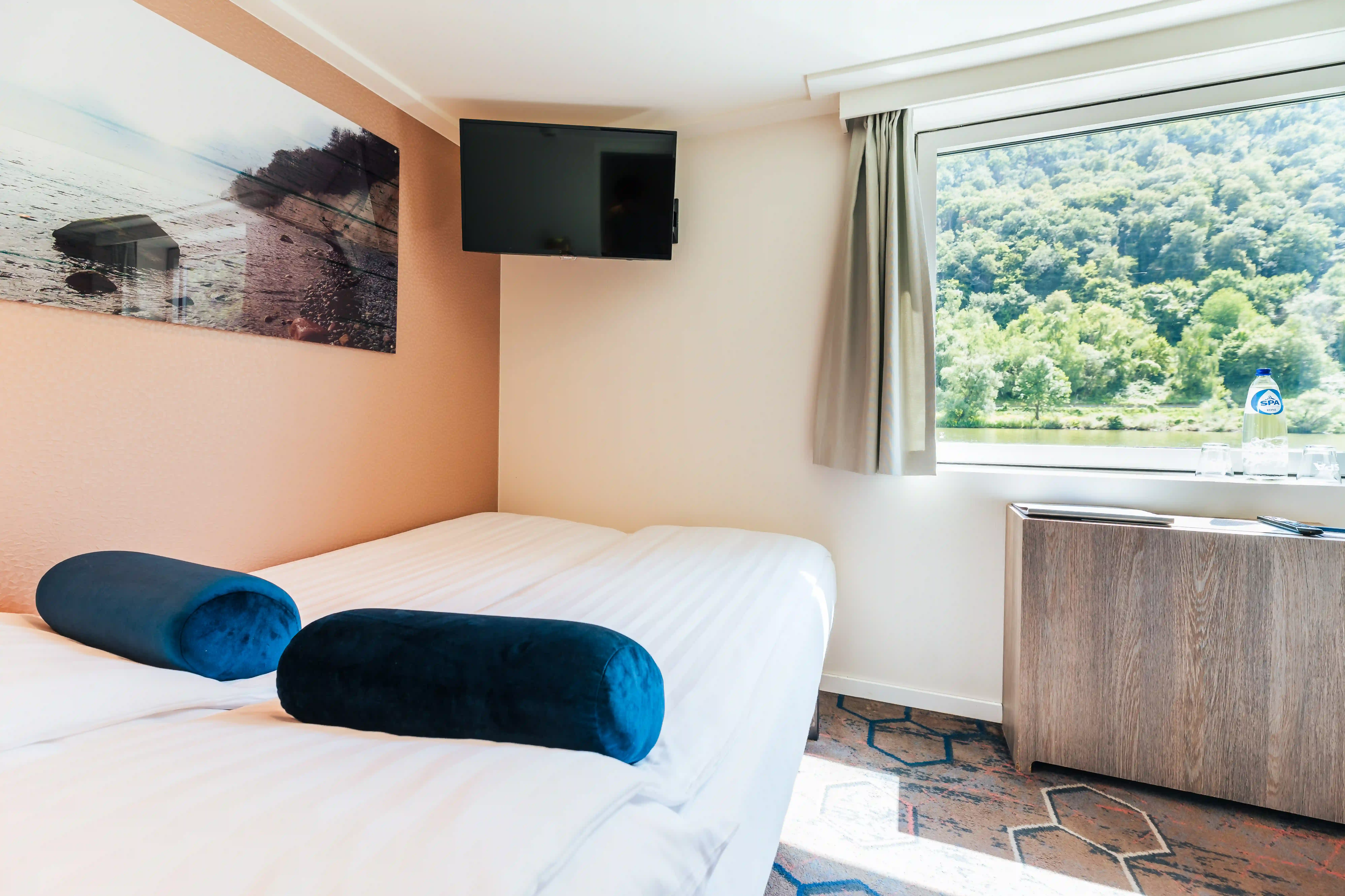 Zweibettkabine mit großem Fenster und Blick auf die Flusslandschaft